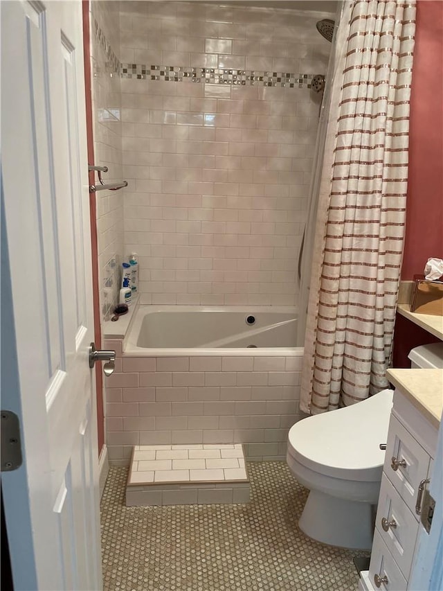 full bathroom featuring vanity, tile patterned floors, toilet, and shower / bath combo