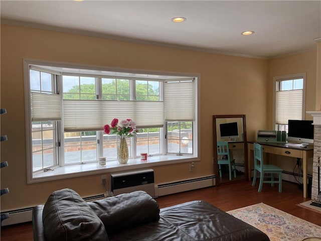 office featuring a healthy amount of sunlight, a baseboard heating unit, and ornamental molding