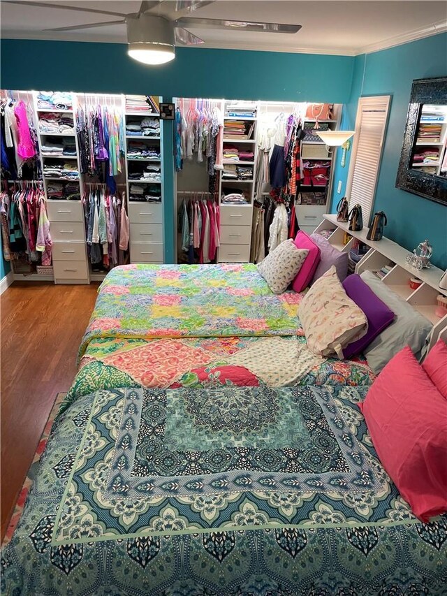 bedroom with hardwood / wood-style flooring and ornamental molding