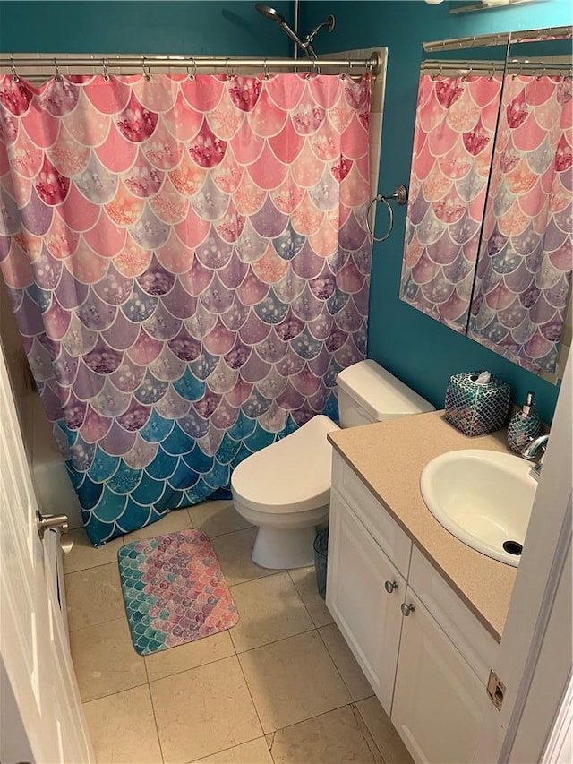 bathroom featuring walk in shower, tile patterned floors, toilet, and vanity