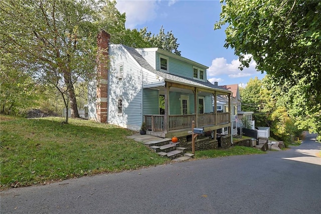 view of front facade with a front yard and a porch