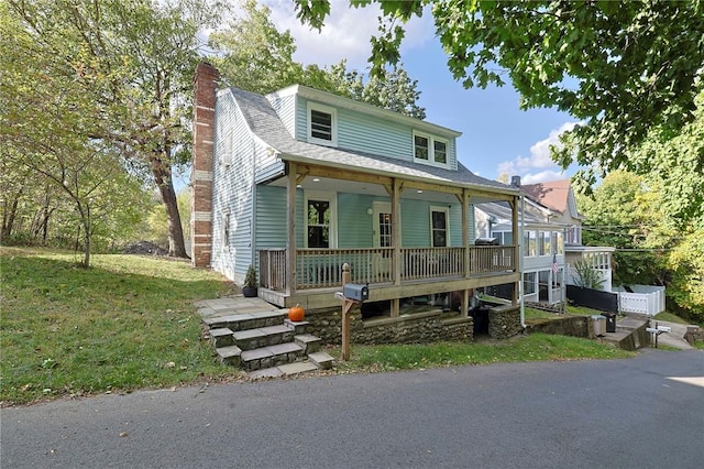 view of front facade with covered porch and a front yard