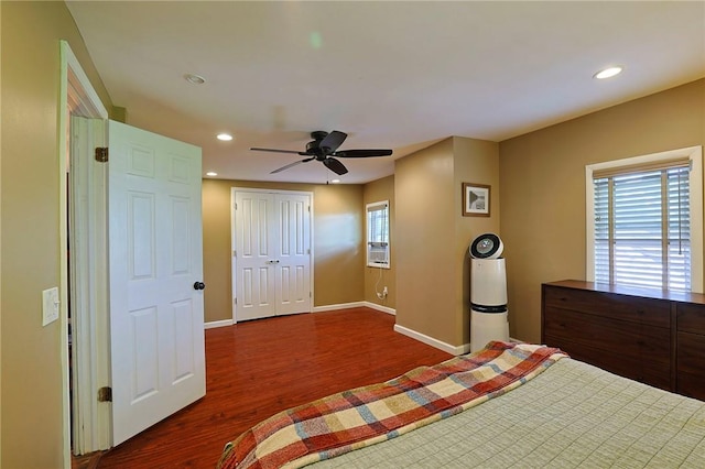 unfurnished bedroom featuring multiple windows, ceiling fan, a closet, and dark hardwood / wood-style floors