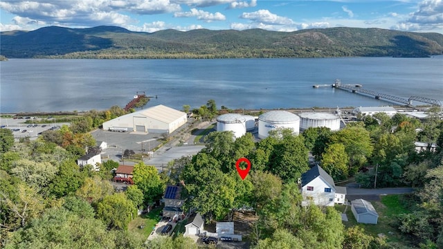 drone / aerial view featuring a water and mountain view