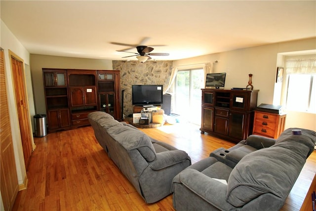 living room with ceiling fan and wood-type flooring