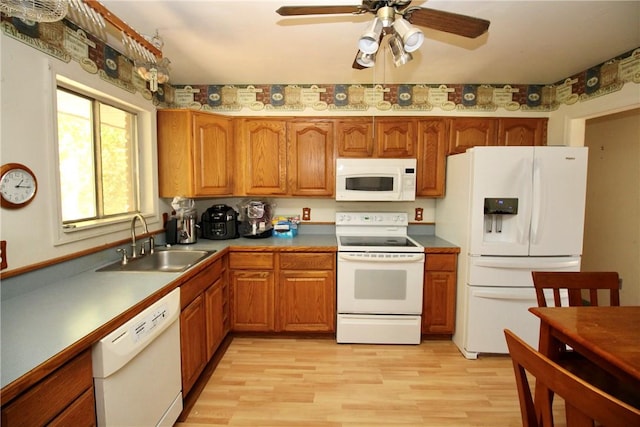 kitchen featuring ceiling fan, sink, white appliances, and light hardwood / wood-style flooring