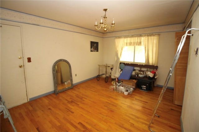 miscellaneous room featuring a chandelier and hardwood / wood-style flooring