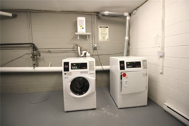 washroom with washer and dryer and a baseboard heating unit