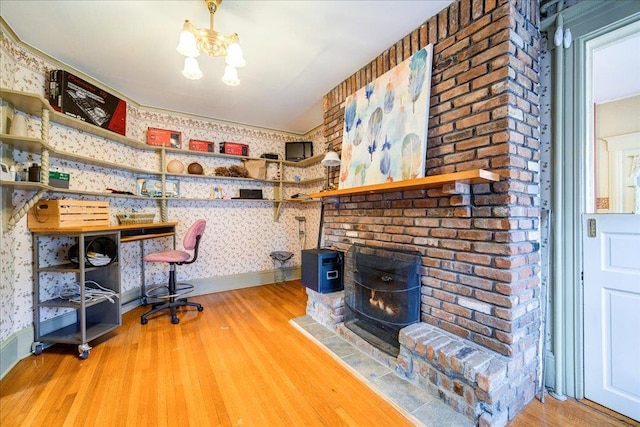 home office with hardwood / wood-style floors and an inviting chandelier