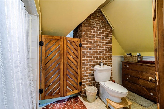 bathroom with toilet and vaulted ceiling