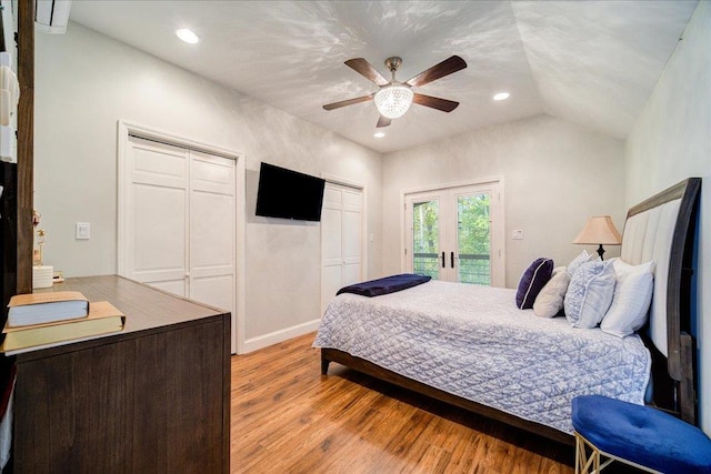 bedroom featuring access to exterior, two closets, ceiling fan, light hardwood / wood-style flooring, and lofted ceiling