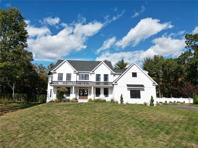 view of front of property with covered porch and a front lawn