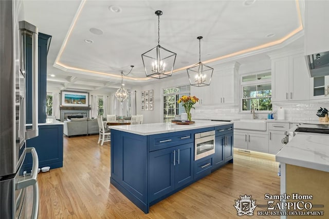 kitchen featuring light hardwood / wood-style flooring, white cabinets, a healthy amount of sunlight, and appliances with stainless steel finishes