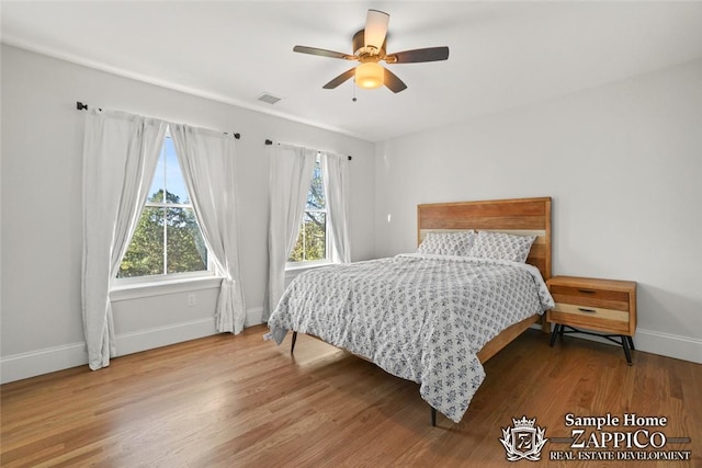 bedroom with hardwood / wood-style floors and ceiling fan