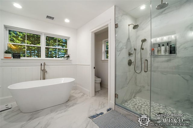 bathroom with shower with separate bathtub and toilet