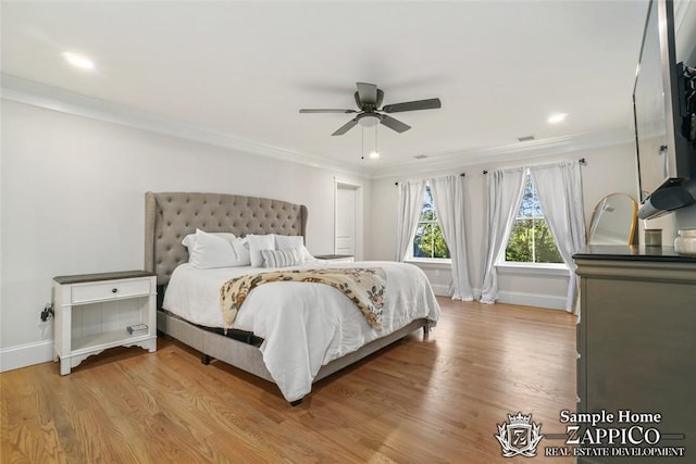 bedroom with ceiling fan, light hardwood / wood-style floors, and crown molding