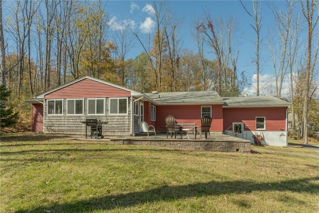 back of property featuring a lawn and a patio area