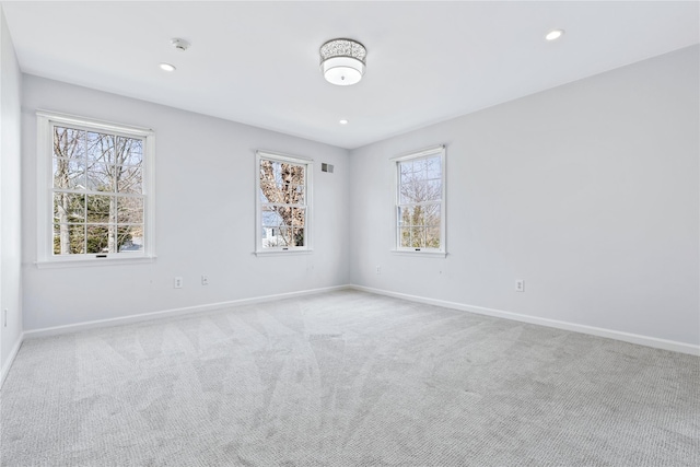 carpeted empty room with baseboards, recessed lighting, and a healthy amount of sunlight