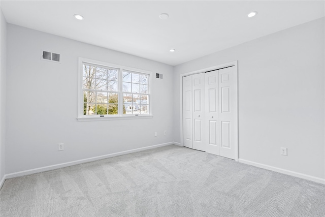 unfurnished bedroom featuring carpet floors, visible vents, and recessed lighting