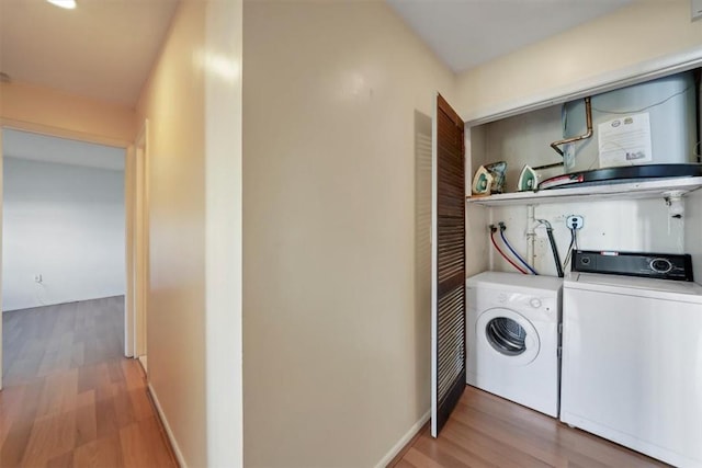 laundry area with washer and dryer and wood-type flooring