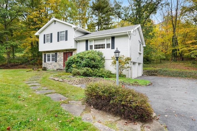 view of front of home with a garage and a front lawn