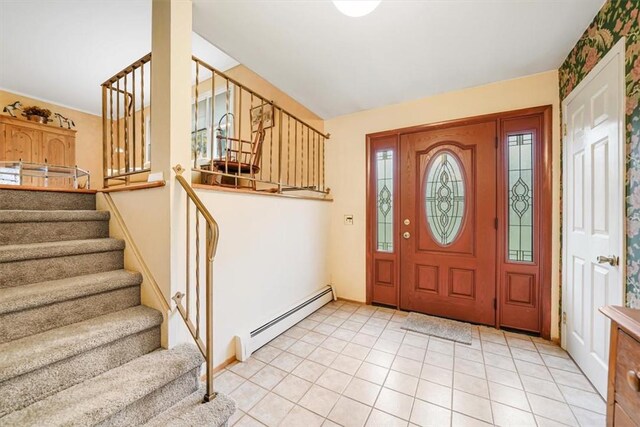 tiled foyer with a baseboard heating unit