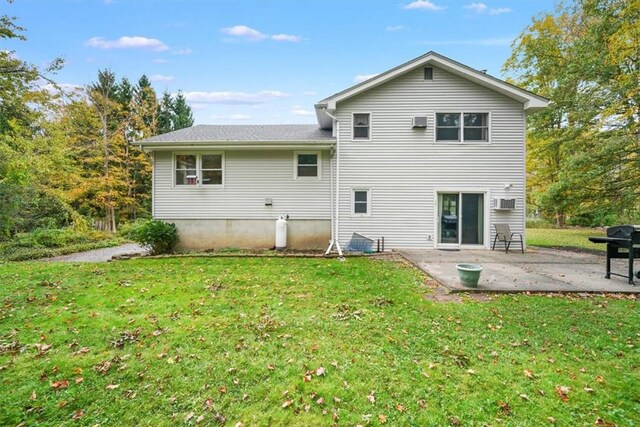 back of property featuring a lawn and a patio area