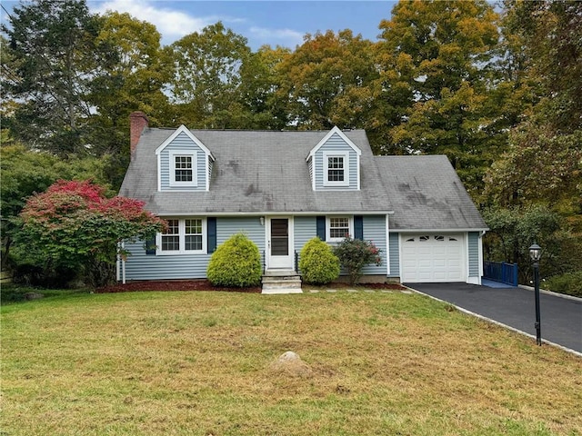 cape cod home with a front yard and a garage