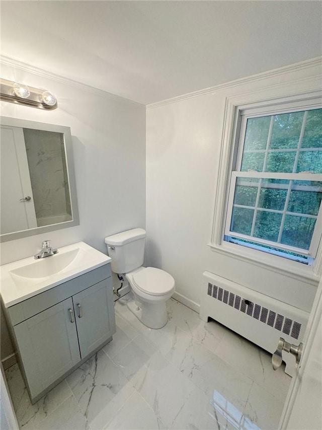 bathroom with radiator, vanity, and toilet