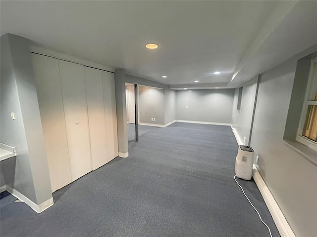 basement featuring dark colored carpet