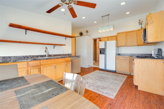 kitchen with light brown cabinets, a sink, open shelves, dark wood-style floors, and stainless steel appliances