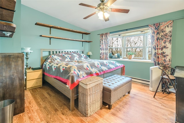 bedroom featuring baseboard heating, wood finished floors, ceiling fan, and vaulted ceiling