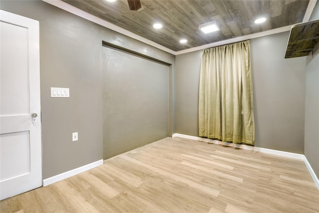 unfurnished room with baseboards, wood finished floors, wooden ceiling, and crown molding