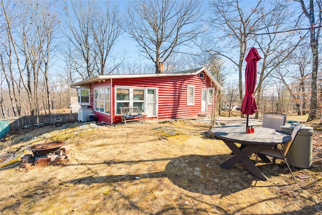 exterior space with fence and an outdoor fire pit