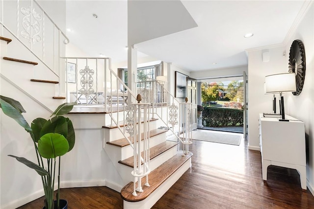 stairs with hardwood / wood-style floors, a wealth of natural light, and ornamental molding