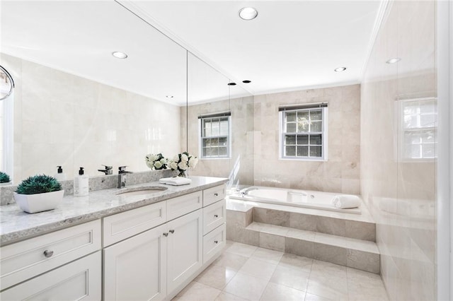 bathroom featuring vanity, tile patterned floors, ornamental molding, tile walls, and tiled bath