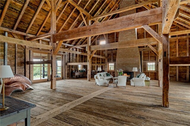 misc room with hardwood / wood-style floors, high vaulted ceiling, and plenty of natural light