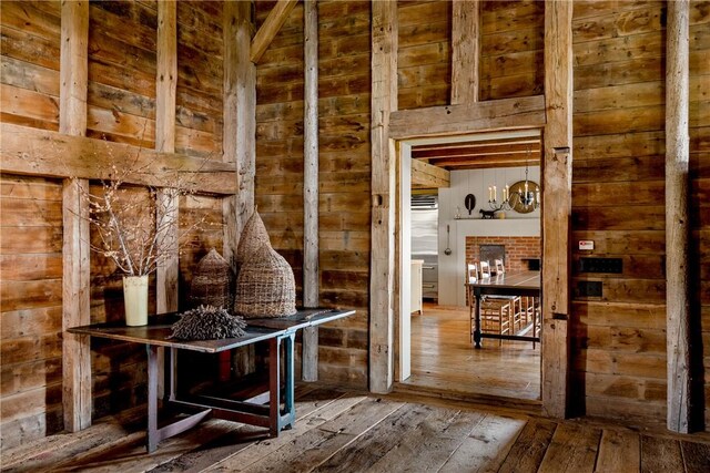 mudroom with wood walls and wood-type flooring