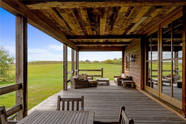 deck with a yard, an outdoor living space, and a rural view