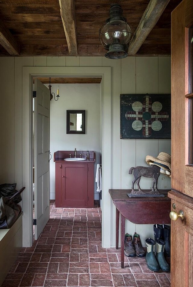 bathroom with beamed ceiling, wood ceiling, and sink