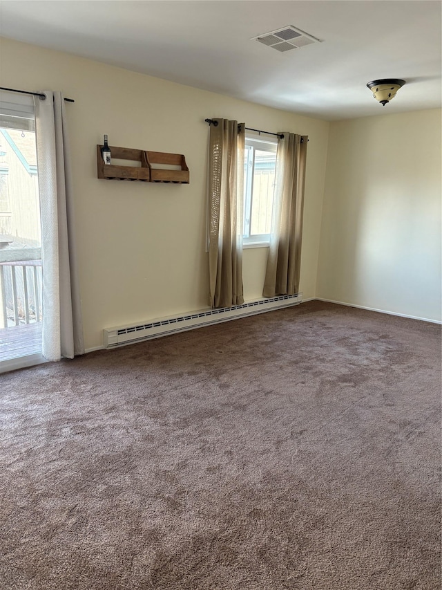 spare room featuring a baseboard radiator and carpet floors