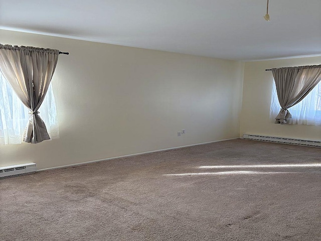 empty room featuring a baseboard radiator and carpet flooring