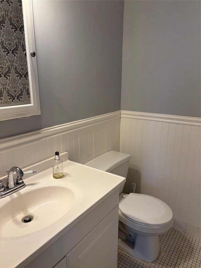 bathroom with tile patterned floors, toilet, and vanity