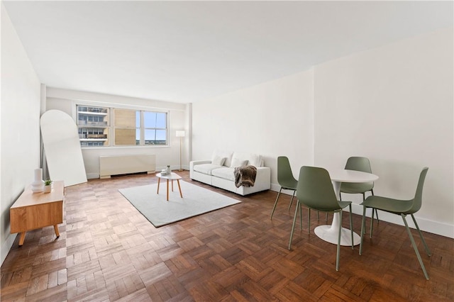 living room with radiator and parquet floors