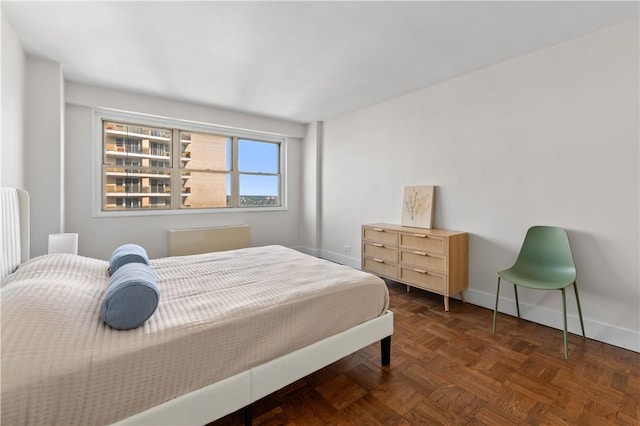 bedroom featuring dark parquet floors