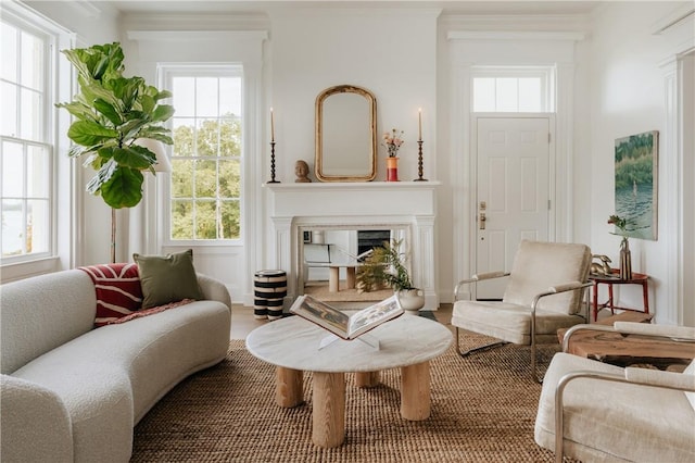 sitting room featuring wood-type flooring and crown molding