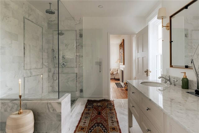 bathroom with walk in shower, vanity, and hardwood / wood-style flooring