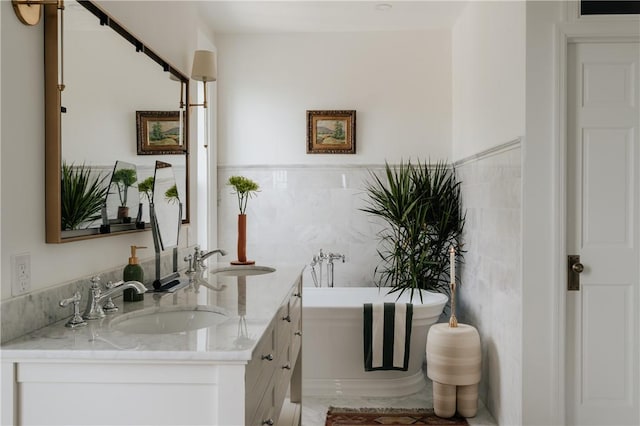 bar with white cabinetry, sink, light stone countertops, and tile walls