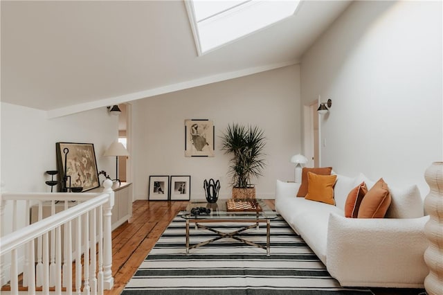 living room featuring light hardwood / wood-style floors and lofted ceiling with skylight