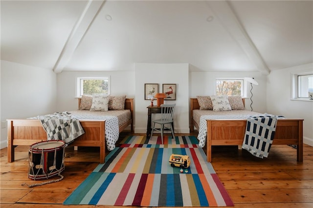 bedroom featuring dark hardwood / wood-style flooring and lofted ceiling with beams